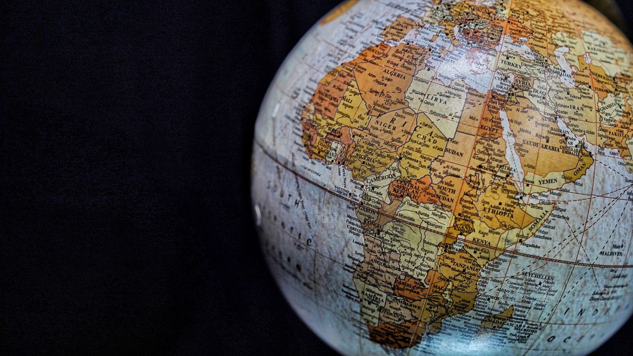 Close-up of a vintage globe highlighting Africa and the Middle East with intricate geography details.