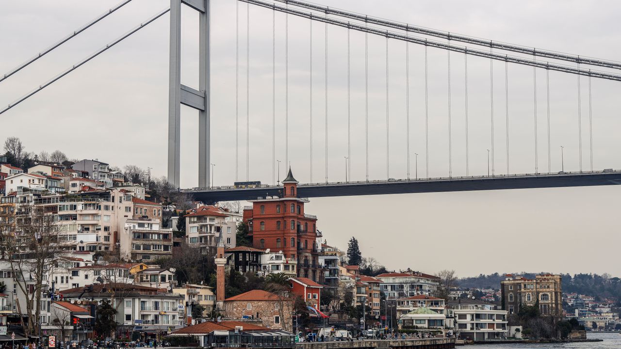 Stunning view of the 15 July Martyrs Bridge over the Bosphorus Strait with Istanbul's vibrant waterfront cityscape.