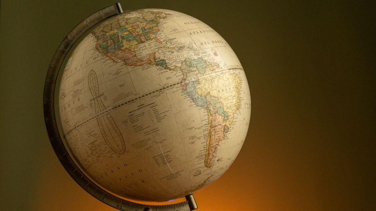 Elegant vintage globe showcasing world geography with a warm ambient background.
