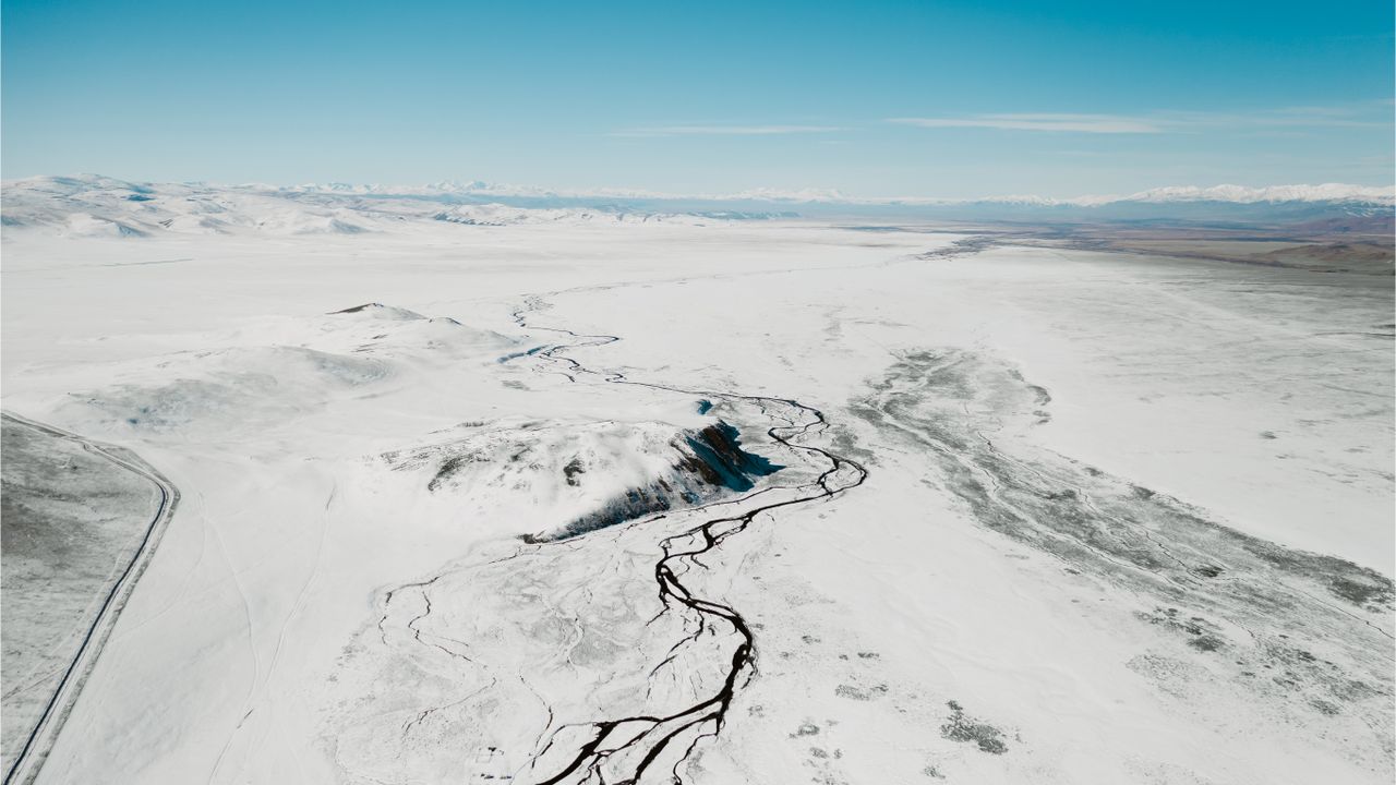 A breathtaking aerial view of a snow-covered landscape in Russia with winding rivers.