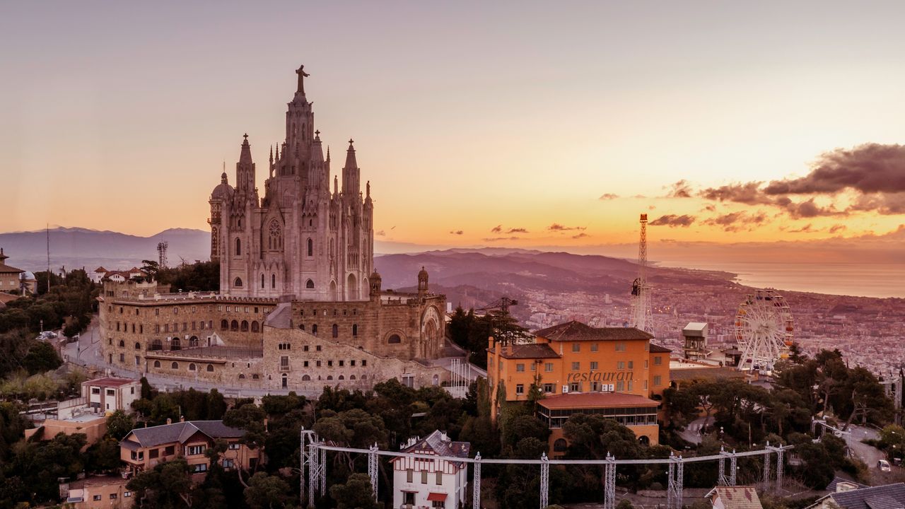 Tibidabo, Barcelona's highest viewpoint, looks west over the city. Exactly the direction the low evening Sun will hang during the eclipse. Photo by Ken Cheung on Pexels.