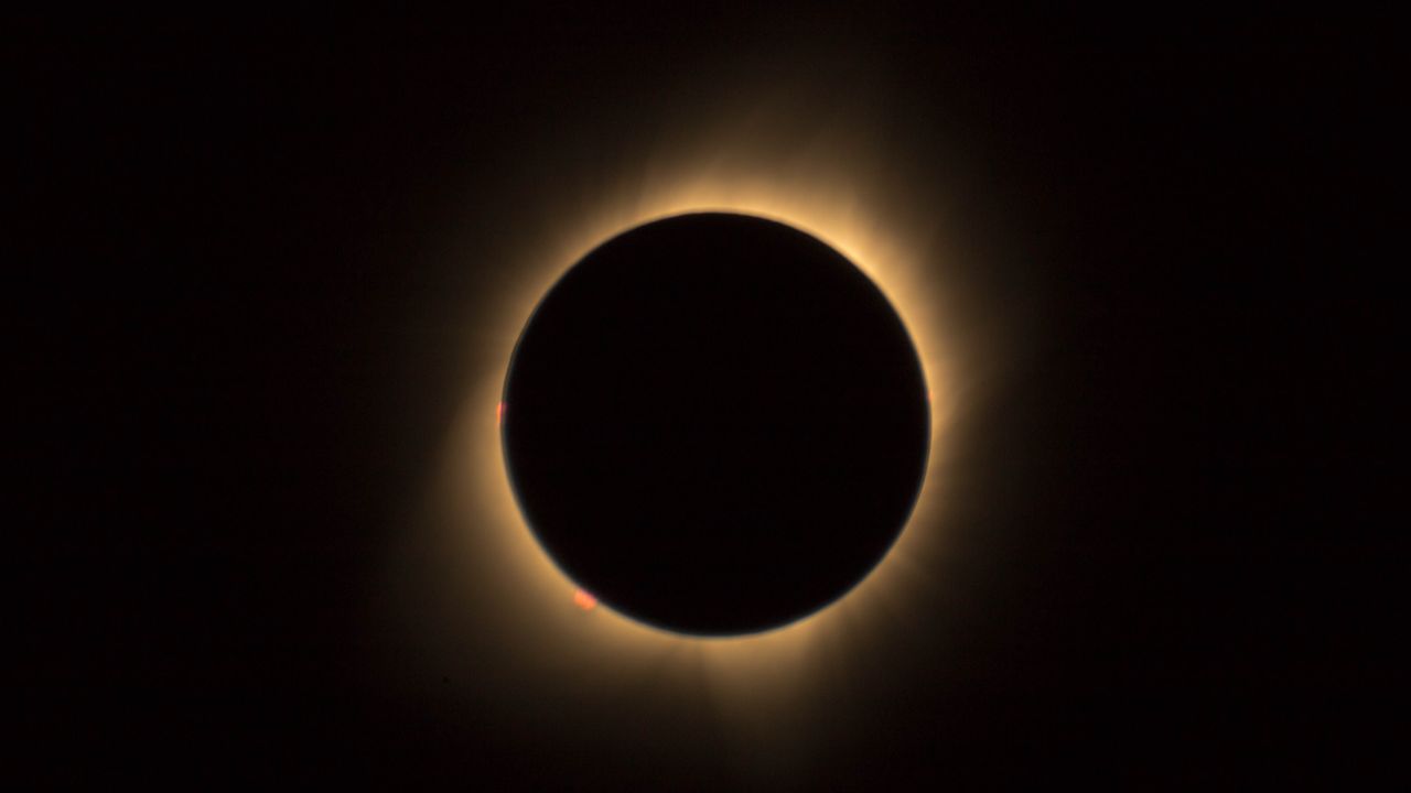 Total solar eclipse at totality, with the Sun's corona glowing around the dark disk of the Moon.
